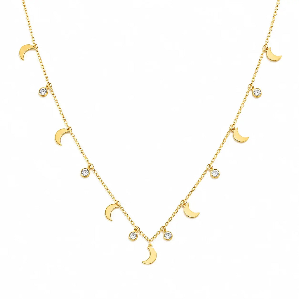 A delicate gold necklace featuring a series of small moon phases and clear round gemstones on a clean white background.