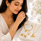 Woman wearing golden butterfly jewelry set with necklace earrings bracelet and ring