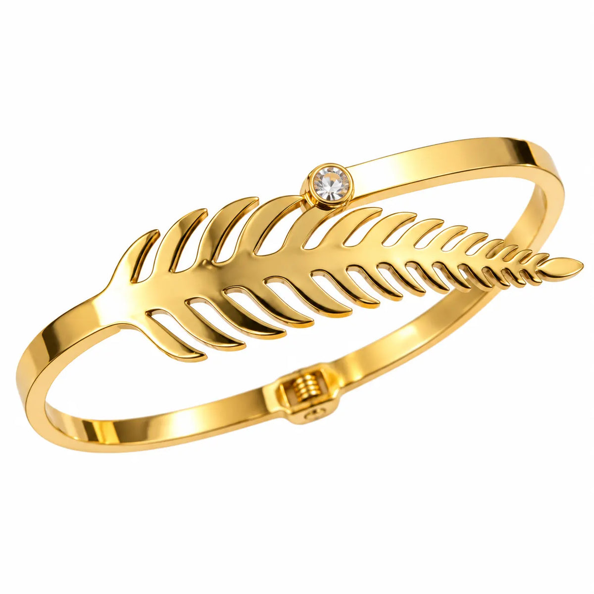 A gold-plated bangle bracelet featuring a stylized fern leaf design and a single clear rhinestone accent, shown on a solid white background.