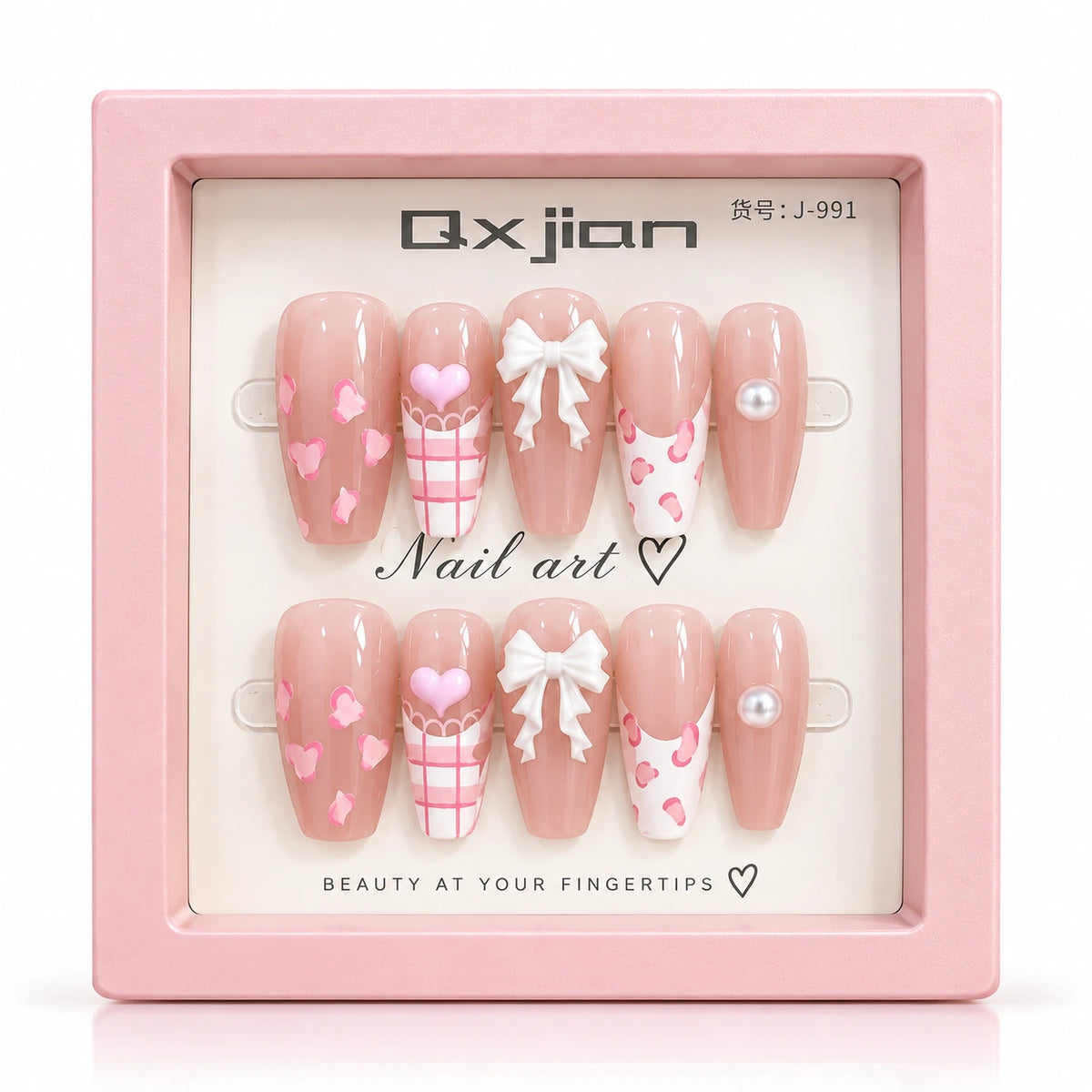 A pair of pink press-on nails displayed in a square pink box. The nails have a glossy nude-pink base with white bows, pink hearts, pink plaid patterns, and pearl accents.