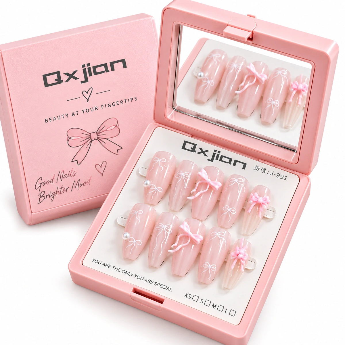 Pink press-on nail set with bow and floral designs, shown in an open pink case with a mirror, alongside the matching pink Qxjian box.